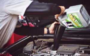 car mechanic doing an oil change in a car